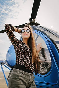 woman standing near blue helicopter thumbnail