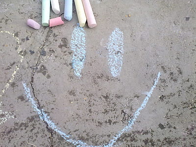 happy face chalk art on concrete pavement thumbnail