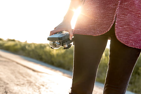 person standing and holding drone thumbnail