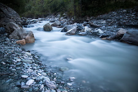 time lapse photography of river between stones thumbnail