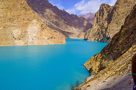 landscape photography of body of water surrounded by mountains thumbnail