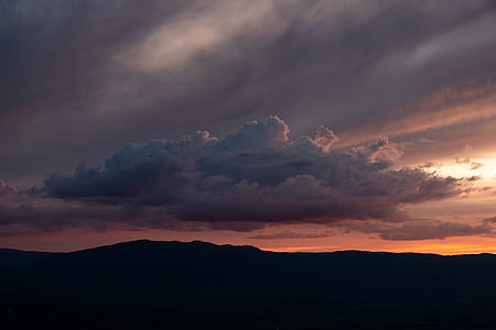 silhouette of mountain under white cloud during sunset thumbnail