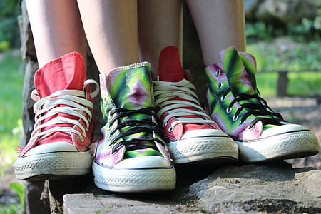person wearing two pairs of red and green mid-rise shoes during daytime thumbnail