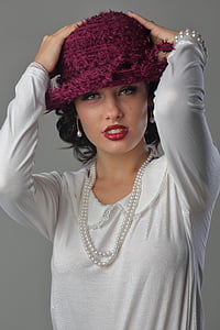 woman wearing pink knit cap touching her head thumbnail