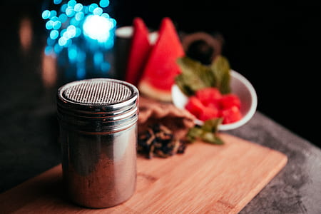 gray stainless steel canister on brown wooden chopping board thumbnail