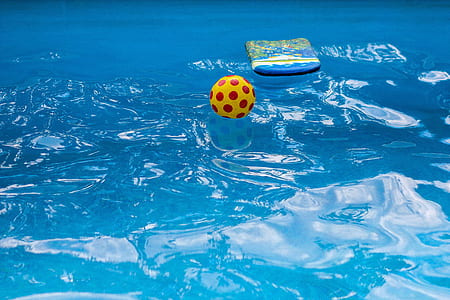yellow and red soccerball on body of water thumbnail