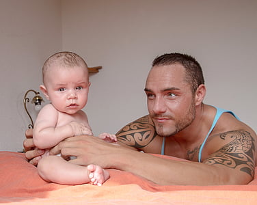 photo of man holding baby thumbnail