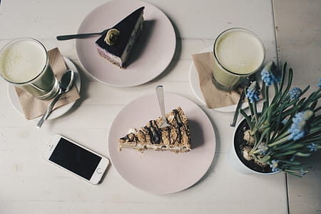 Photo of Sliced Cakes and Milk tea Near Plant thumbnail