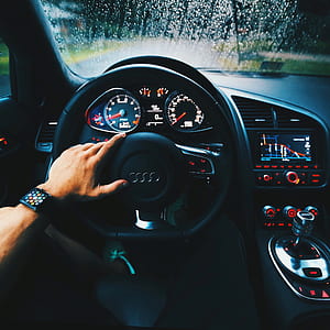 person driving Audi car thumbnail