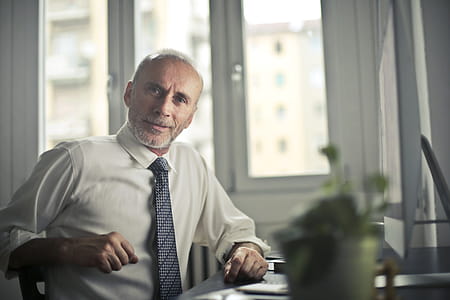 Man Sitting on Chair Beside Table thumbnail