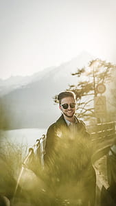 man standing on bridge talking photo thumbnail