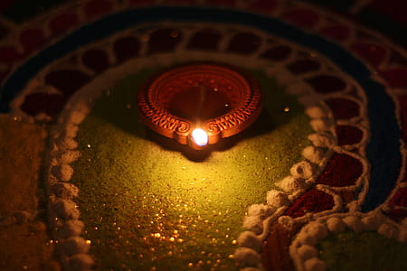 red lighted candle in dimmed room thumbnail