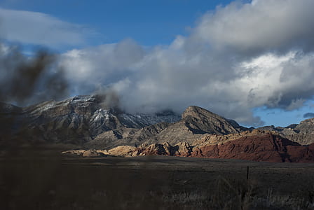 mountains under cloudy blue sky during daytime thumbnail