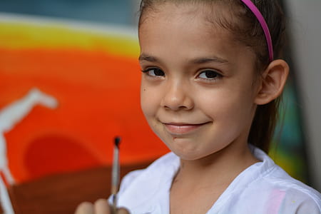 selective focus photography of girl wearing pink alice band thumbnail
