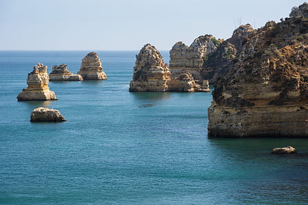 gray rock formations in sea at daytime thumbnail