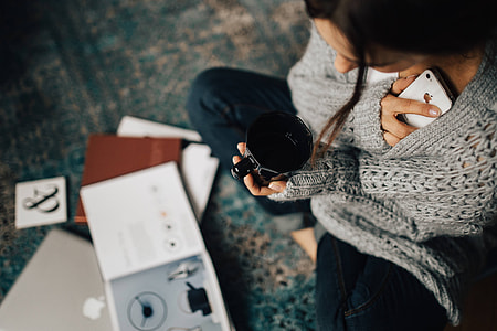 Woman reading magazines on the floor while enjoying her cup of tea thumbnail