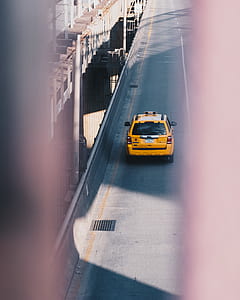 yellow cab on gray concrete road during daytime thumbnail
