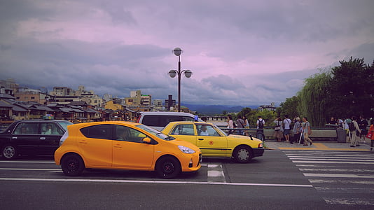 vehicles halting in front of pedestrian crossing during daytime thumbnail