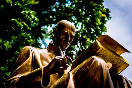 statue of man reading close-up photo during daytime thumbnail