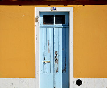 person showing blue wooden door thumbnail