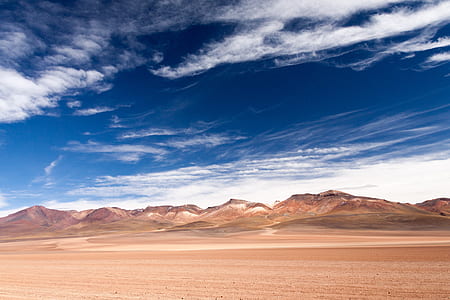 sand dune near mountain range under cumulus cloud thumbnail