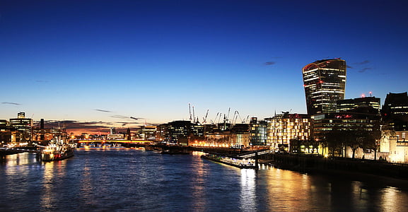 aerial photography of lighted city near body of water thumbnail