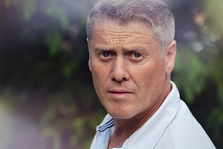 close-up photography of man wearing white polo shitr thumbnail