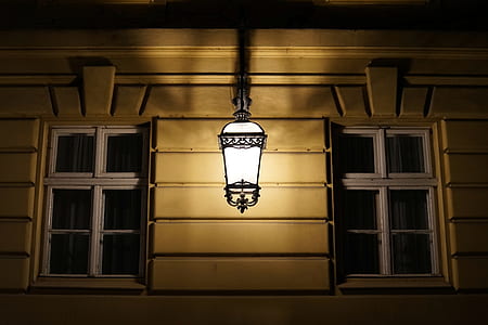 black wall sconce turned on thumbnail