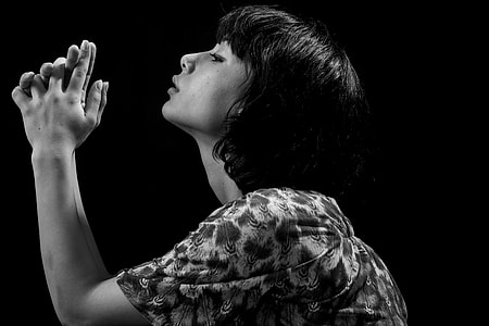 woman in floral top raising two hands in grayscale photography thumbnail