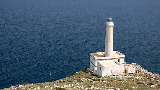 White Lighthouse on Cliff Near Body of Water thumbnail