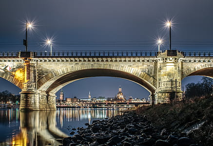 beige concrete bridge under cloudy sky thumbnail
