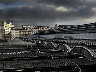 portrait photography of structure roof under dark clouds during daytime thumbnail