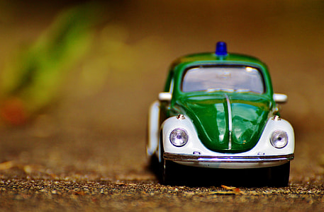 selective-focus photography of green Volkswagen Beetle thumbnail