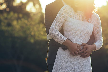 man holding hands with woman on waist during sunset thumbnail
