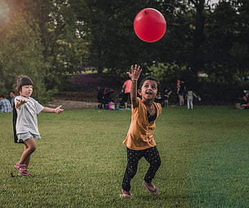 two boy and girl playing with red balloon thumbnail