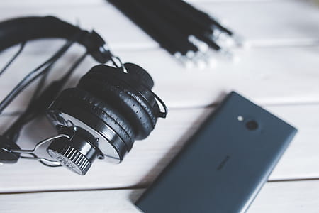 Closeup of  headphones with smart phone thumbnail