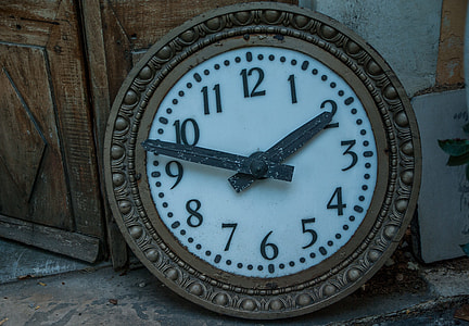 round brown and white analog wall clock pointing at 2:58 thumbnail