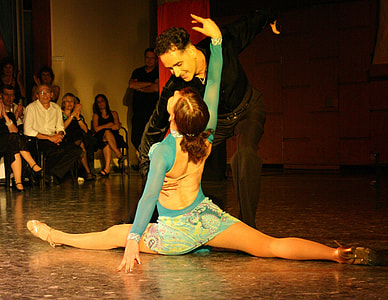 man and woman dancing in front of people thumbnail