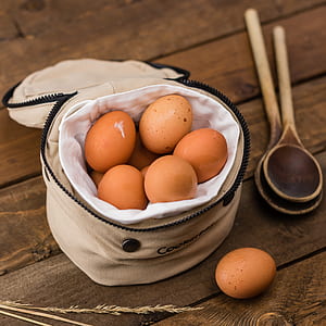 brown eggs in beige bag beside ladles thumbnail
