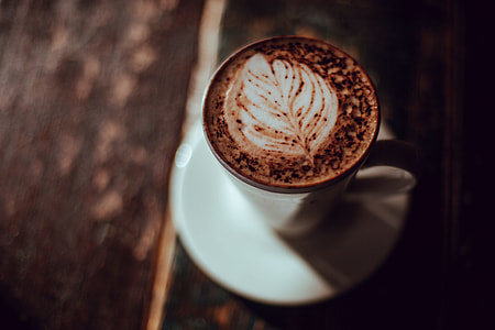 shallow focus photo of brown and white liquid-filled ceramic mug on saucer thumbnail