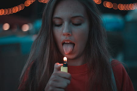 woman lighting yellow disposable lighter thumbnail