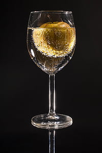 clear wine glass with liquid and brown apple thumbnail