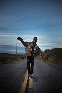 man standing on center of street thumbnail