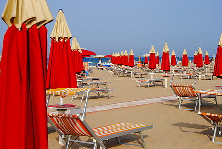red, gray, and beige beach loungers and umbrellas at daytime thumbnail