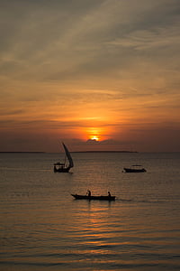 three boat on the ocean during golden hour photography thumbnail