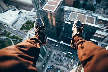 man sitting on edge of building thumbnail
