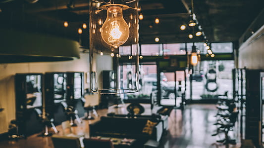 closeup photo of orange pendant light near table with chair set inside room thumbnail