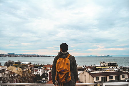 man wearing backpack and wearing hooded jacket thumbnail