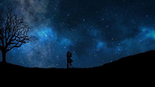 silhouette of man and woman under the starry night thumbnail