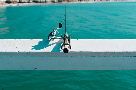brown and black fishing rod thumbnail